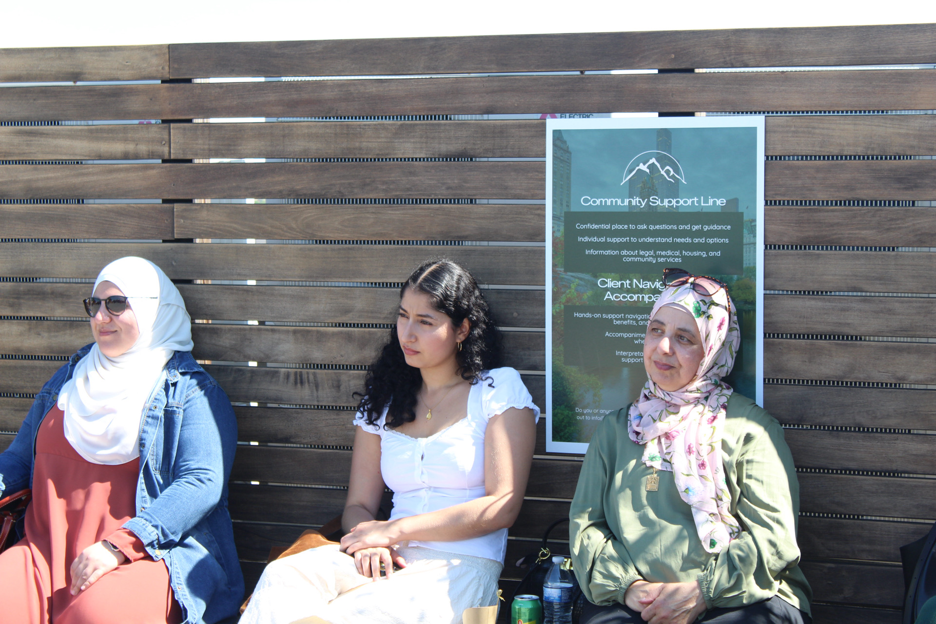 Guests seated near a Safa Sanctuary service poster