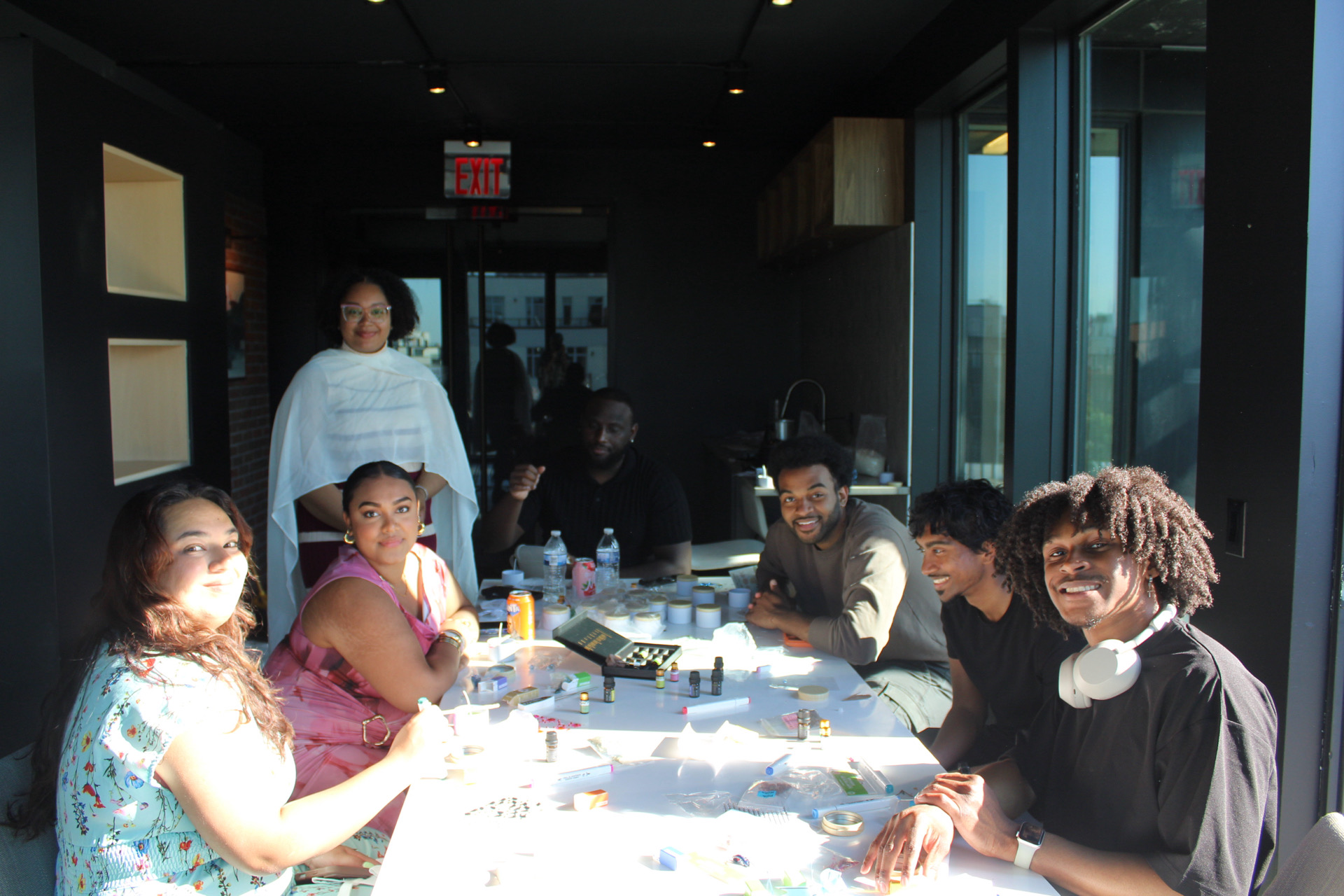 Community members gathered around a workshop table